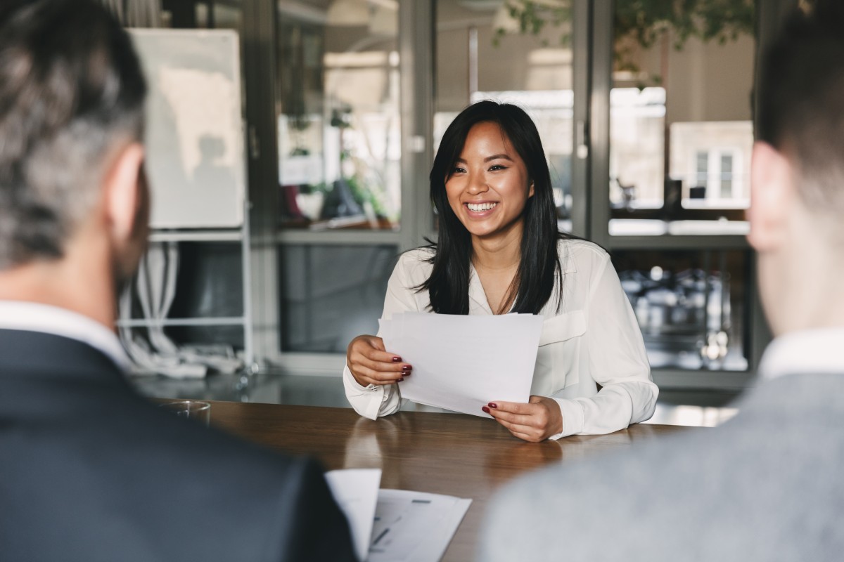 a woman holding a piece of paper