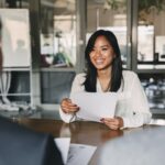 a woman holding a piece of paper