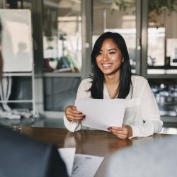 a woman holding a piece of paper