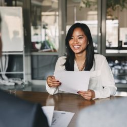 a woman holding a piece of paper